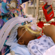 Dr. Anu Patel removes a Game Boy hand-held game from the hands of Nykia Crawford who was just sedated for an operation at University Hospital in Newark, N.J., Tuesday, Dec. 7, 2004.